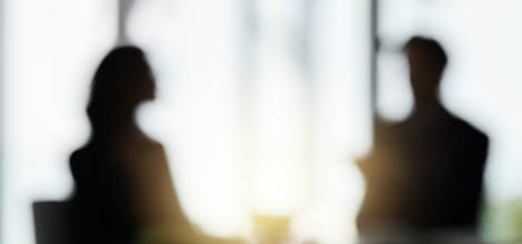 Blurred image of doctor and patient talking